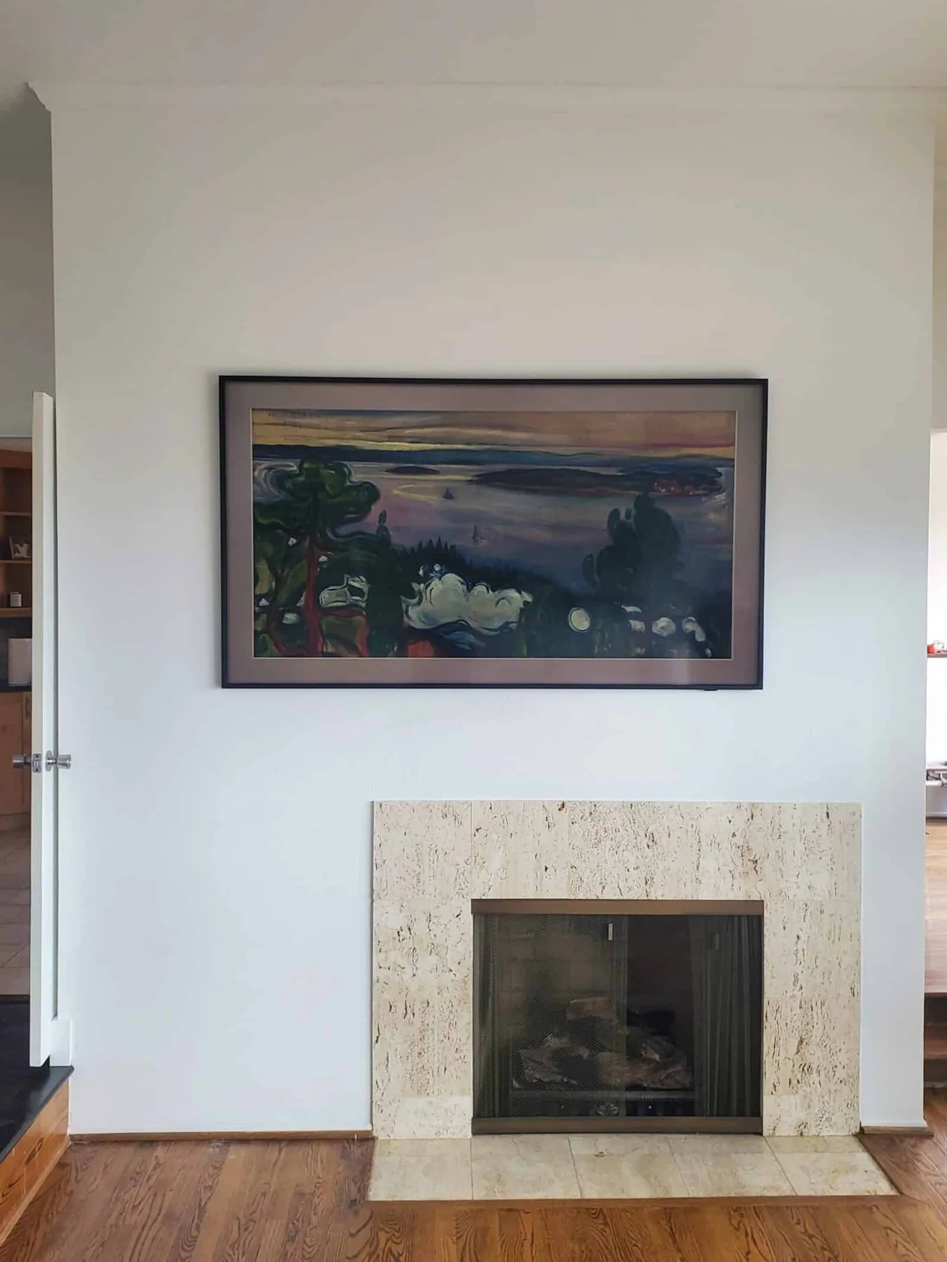 Frame-style TV centered above a tiled fireplace