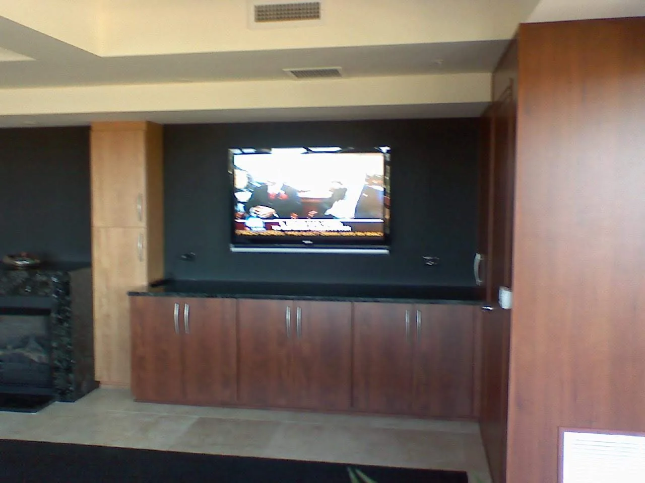 TV integrated into a recessed media wall above custom cabinetry