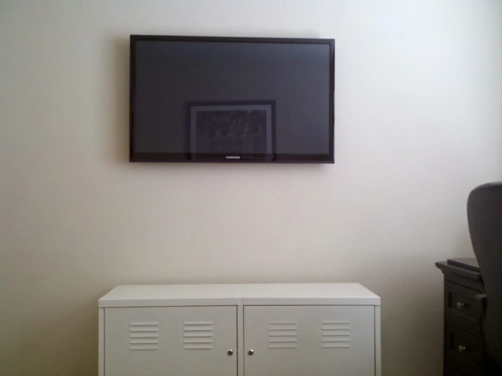 Wall-mounted TV above a freestanding media cabinet