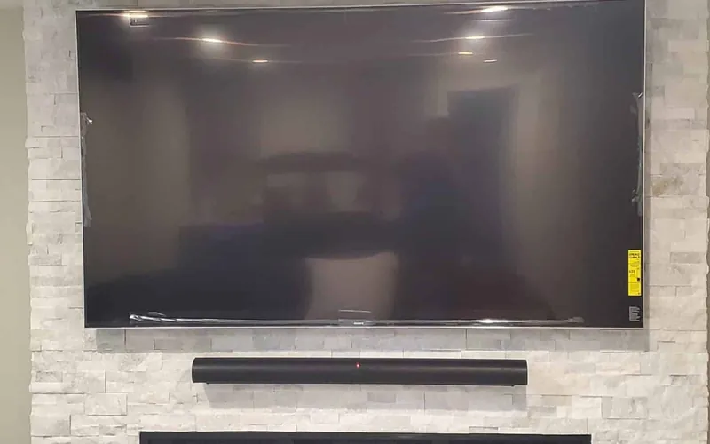 Mounted television and soundbar with a clean finished wall